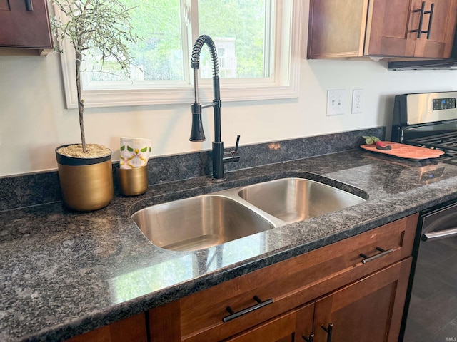 22073 County Road 10 W, Elkhart, IN 46514 - kitchen view of a sink, dishwashing machine, dark stone countertops, and brown cabinetry