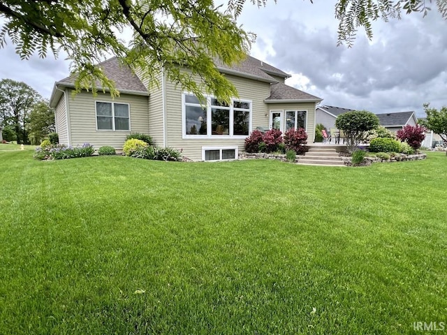 1442 Centerbrook Dr, New Haven, IN 46774 - rear view of house with roof with shingles and a lawn