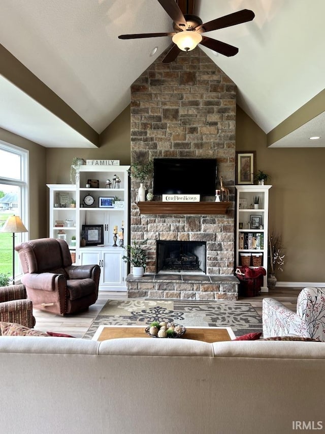 1442 Centerbrook Dr, New Haven, IN 46774 - living room featuring a ceiling fan, wood finished floors, a fireplace, and vaulted ceiling