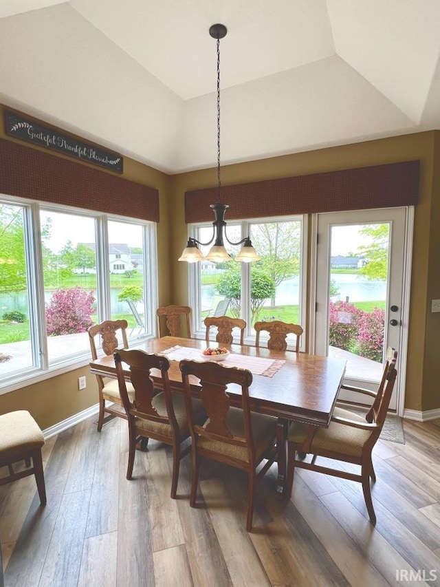 1442 Centerbrook Dr, New Haven, IN 46774 - dining room featuring light wood-style flooring, baseboards, a tray ceiling, and a chandelier