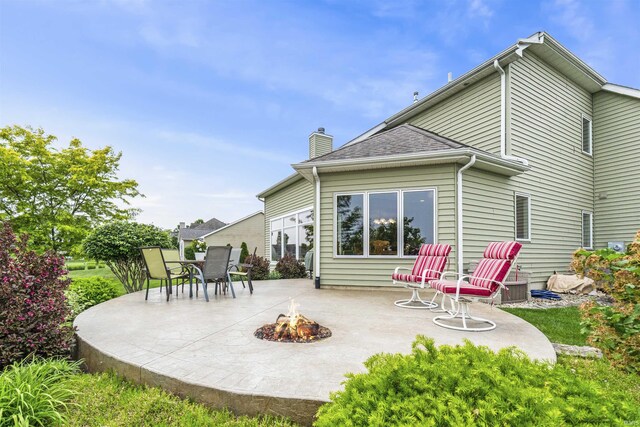 1442 Centerbrook Dr, New Haven, IN 46774 - rear view of house featuring a fire pit, a patio, and a chimney
