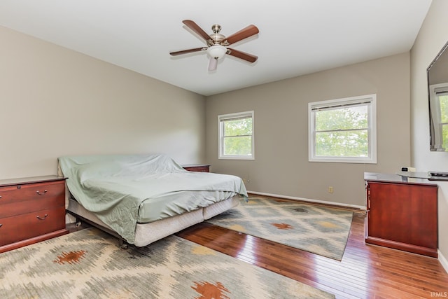 501 W Fox Lake Rd, Angola, IN 46730 - bedroom with hardwood / wood-style flooring, baseboards, and a ceiling fan