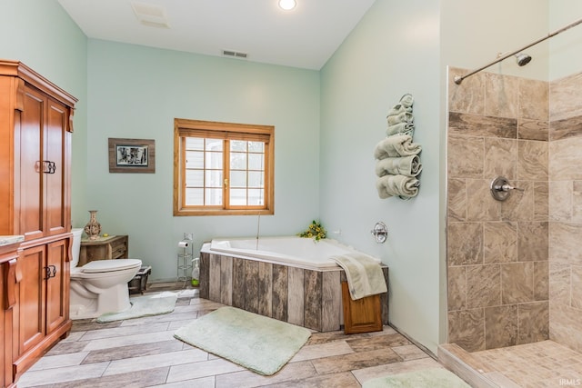 501 W Fox Lake Rd, Angola, IN 46730 - full bath featuring a bath, toilet, tiled shower, and recessed lighting