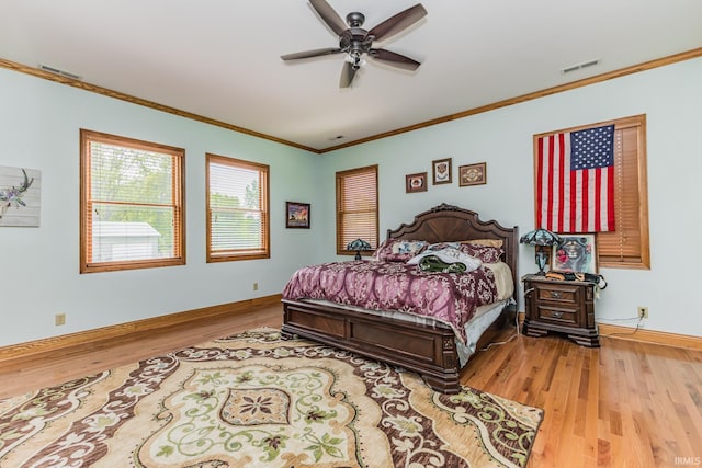 501 W Fox Lake Rd, Angola, IN 46730 - bedroom featuring wood finished floors, ornamental molding, baseboards, and a ceiling fan