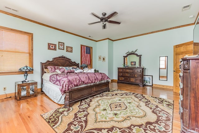501 W Fox Lake Rd, Angola, IN 46730 - bedroom with wood finished floors, crown molding, baseboards, and a ceiling fan