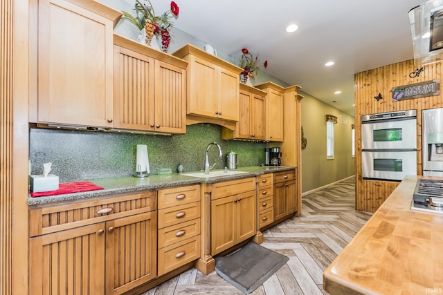 501 W Fox Lake Rd, Angola, IN 46730 - kitchen featuring a sink, wooden counters, stainless steel appliances, decorative backsplash, and baseboards