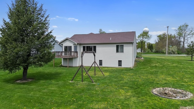 612 E Dunn Rd, New Carlisle, IN 46552 - rear view of house featuring a lawn and a deck