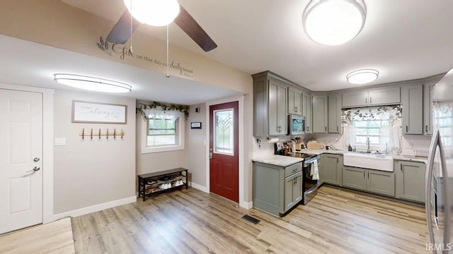 5480 S 950 W, South Whitley, IN 46787 - kitchen with stainless steel appliances, gray cabinets, a sink, and light wood-style floors