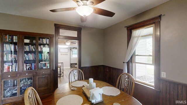 5480 S 950 W, South Whitley, IN 46787 - dining room featuring a wainscoted wall, wood walls, and ceiling fan