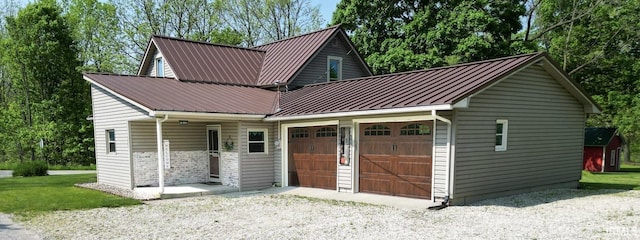 5480 S 950 W, South Whitley, IN 46787 - view of front of house featuring a garage and metal roof