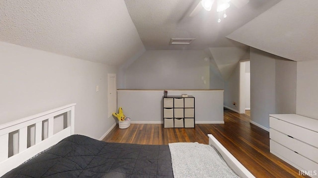 5480 S 950 W, South Whitley, IN 46787 - bedroom with wood finished floors, lofted ceiling, baseboards, and a textured ceiling
