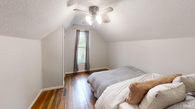 5480 S 950 W, South Whitley, IN 46787 - bedroom with baseboards, a textured ceiling, hardwood / wood-style floors, vaulted ceiling, and ceiling fan
