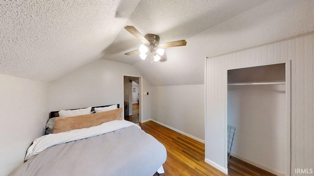 5480 S 950 W, South Whitley, IN 46787 - bedroom with wood finished floors, a textured ceiling, a ceiling fan, a closet, and vaulted ceiling