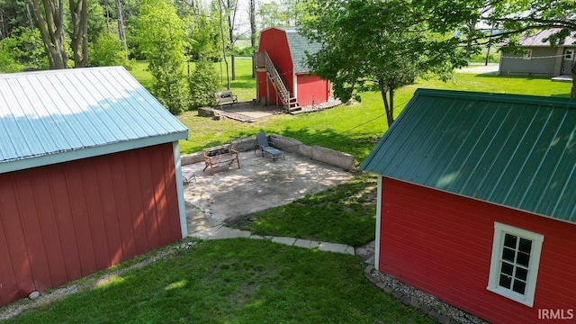 5480 S 950 W, South Whitley, IN 46787 - view of grassy yard featuring an outbuilding and a patio