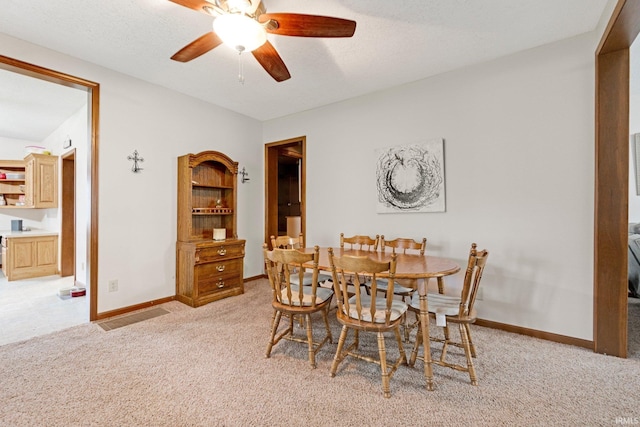 517 N Nancy St, Warren, IN 46792 - dining space featuring light colored carpet, ceiling fan, and baseboards