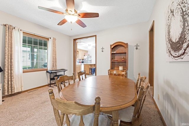 517 N Nancy St, Warren, IN 46792 - dining space featuring a ceiling fan, carpet floors, a textured ceiling, and baseboards