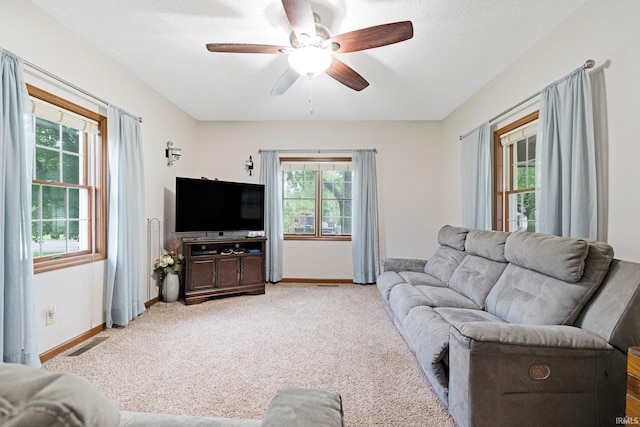 517 N Nancy St, Warren, IN 46792 - living room with healthy amount of natural light, a ceiling fan, baseboards, and light carpet