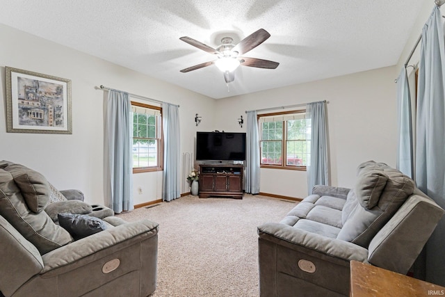 517 N Nancy St, Warren, IN 46792 - living area with light colored carpet, baseboards, ceiling fan, and a textured ceiling