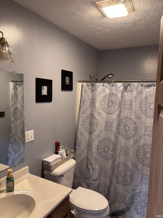 311 Hampshire Dr, Logansport, IN 46947 - bathroom featuring vanity, toilet, a textured ceiling, and a shower with shower curtain