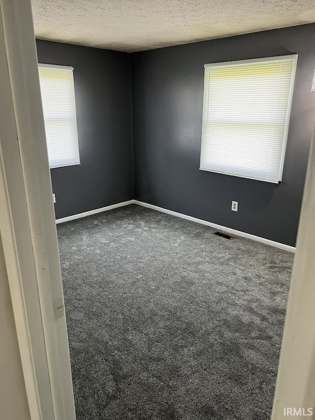 7109 W 100 S, Wabash, IN 46992 - empty room with a textured ceiling, carpet flooring, and baseboards
