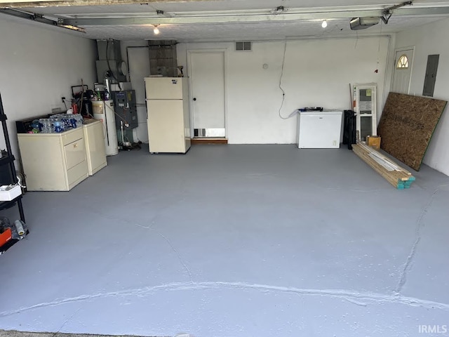 7109 W 100 S, Wabash, IN 46992 - garage featuring freestanding refrigerator, washing machine and dryer, electric panel, a garage door opener, and fridge