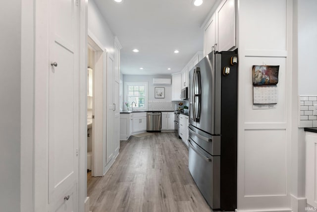 2215 Kensington Blvd, Fort Wayne, IN 46805 - kitchen featuring appliances with stainless steel finishes, a wall unit AC, white cabinetry, decorative backsplash, and recessed lighting