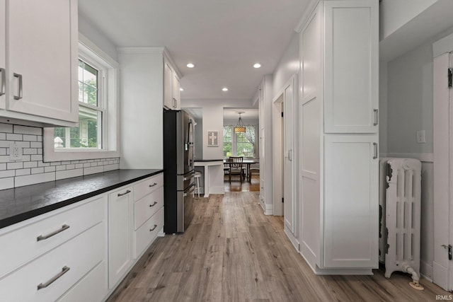 2215 Kensington Blvd, Fort Wayne, IN 46805 - kitchen with radiator heating unit, freestanding refrigerator, dark countertops, white cabinetry, and recessed lighting