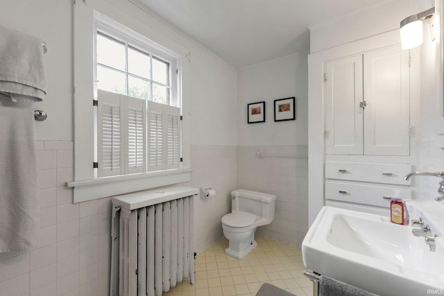 2215 Kensington Blvd, Fort Wayne, IN 46805 - bathroom featuring radiator, tile walls, tile patterned flooring, a wainscoted wall, and toilet