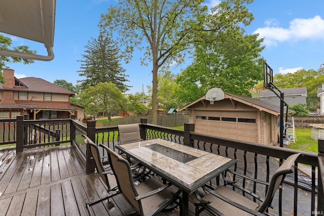 2215 Kensington Blvd, Fort Wayne, IN 46805 - wooden terrace with a garage, outdoor dining area, and an outbuilding