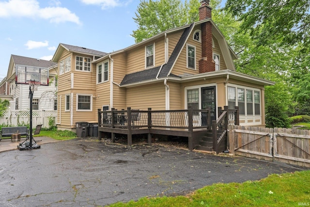 2215 Kensington Blvd, Fort Wayne, IN 46805 - rear view of property with a wooden deck, a chimney, a gate, a patio, and a shingled roof