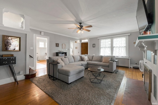 2215 Kensington Blvd, Fort Wayne, IN 46805 - living area featuring radiator, crown molding, a ceiling fan, a fireplace, and baseboards