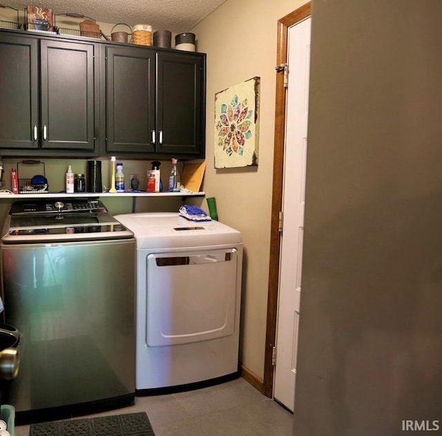 6322 Eagle Nest Ct, Fort Wayne, IN 46814 - washroom with cabinet space, washer and dryer, a textured ceiling, and light tile patterned floors