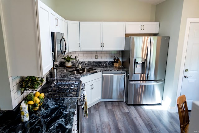 3850 W Woodmere Ct, Bloomington, IN 47403 - kitchen featuring appliances with stainless steel finishes, a sink, backsplash, wood finished floors, and white cabinets