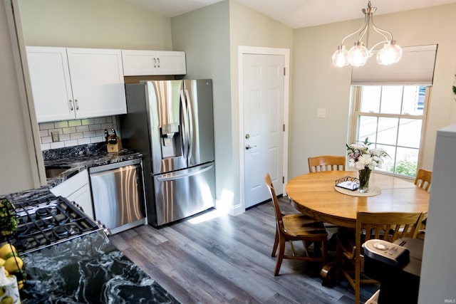3850 W Woodmere Ct, Bloomington, IN 47403 - kitchen with stainless steel appliances, dark wood finished floors, tasteful backsplash, white cabinetry, and a chandelier