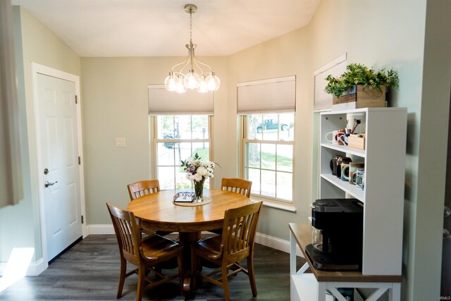 3850 W Woodmere Ct, Bloomington, IN 47403 - dining room featuring a chandelier, dark wood-style floors, and baseboards