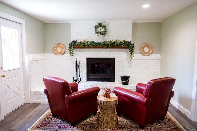 3850 W Woodmere Ct, Bloomington, IN 47403 - living room featuring wood finished floors, a brick fireplace, recessed lighting, and crown molding