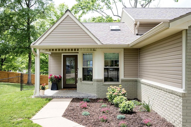 3850 W Woodmere Ct, Bloomington, IN 47403 - view of exterior entry featuring roof with shingles and brick siding