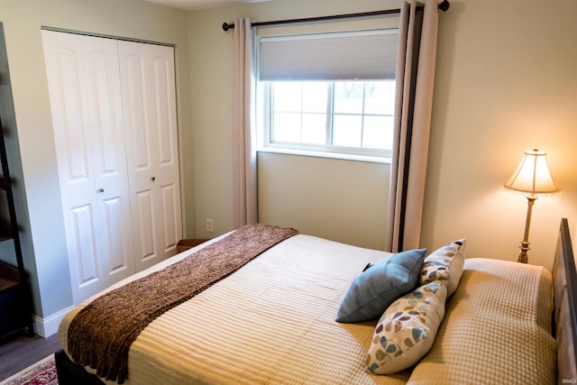 3850 W Woodmere Ct, Bloomington, IN 47403 - bedroom featuring a closet, wood finished floors, and baseboards