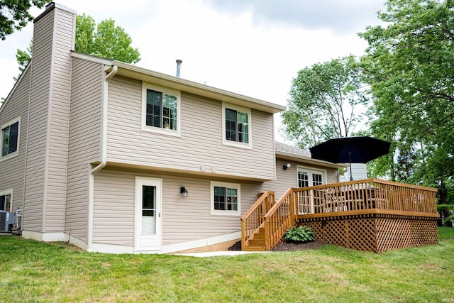 3850 W Woodmere Ct, Bloomington, IN 47403 - rear view of property featuring a deck, a chimney, and a yard