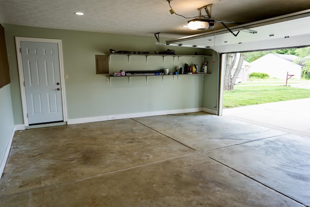 3850 W Woodmere Ct, Bloomington, IN 47403 - garage featuring a garage door opener, baseboards, and recessed lighting