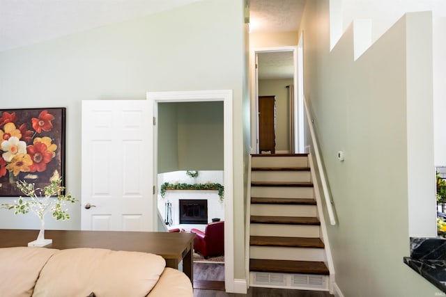 3850 W Woodmere Ct, Bloomington, IN 47403 - stairs with wood finished floors and a glass covered fireplace