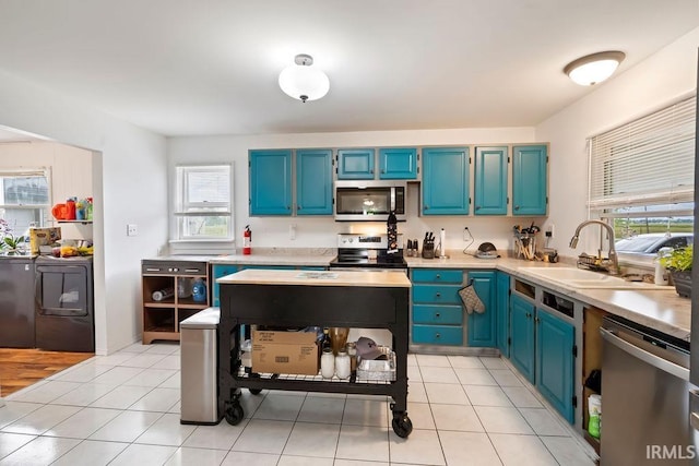 6659 W 400 S, Swayzee, IN 46986 - kitchen featuring appliances with stainless steel finishes, a sink, blue cabinets, and healthy amount of natural light