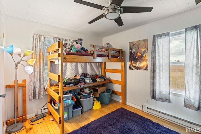 6659 W 400 S, Swayzee, IN 46986 - bedroom with a baseboard heating unit, hardwood / wood-style floors, multiple windows, and ceiling fan