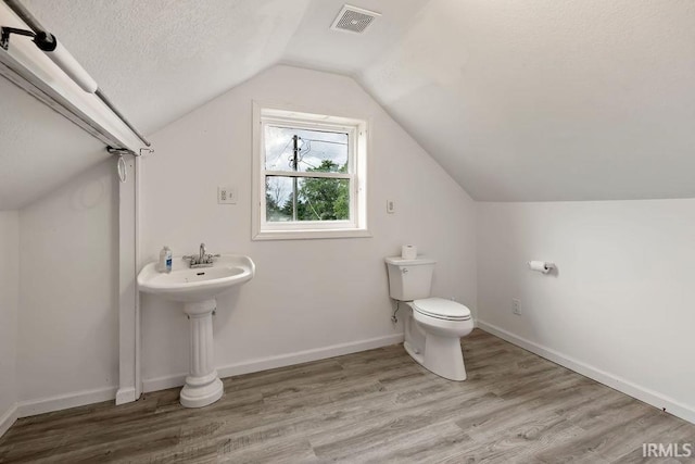 6659 W 400 S, Swayzee, IN 46986 - bathroom featuring toilet, lofted ceiling, wood finished floors, a textured ceiling, and baseboards