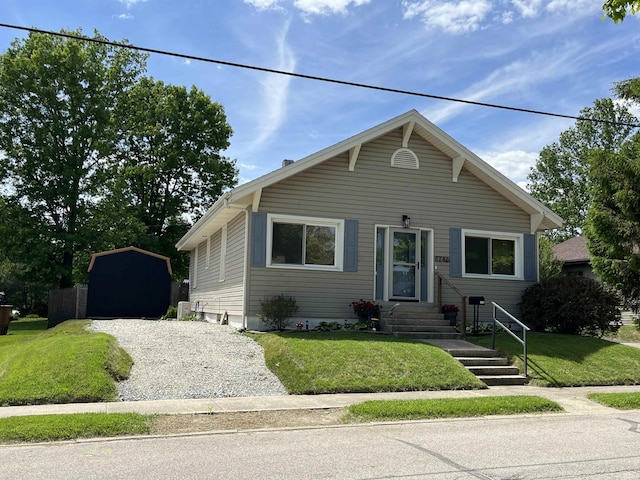 1746 College Ave, Huntington, IN 46750 - bungalow with a front lawn, an outbuilding, and gravel driveway