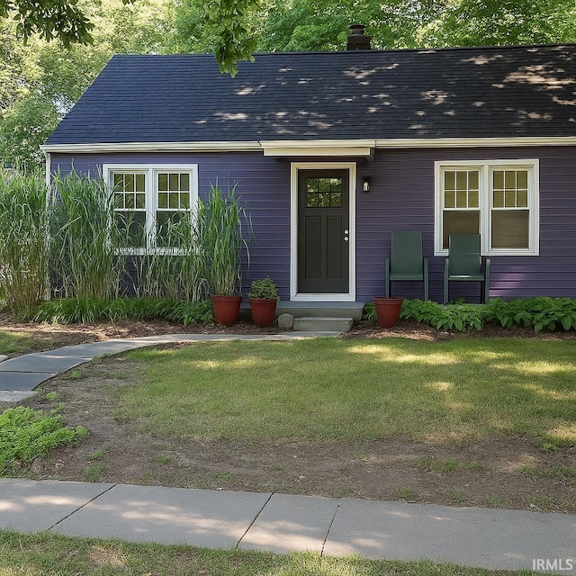 204 Dehart St, West Lafayette, IN 47906 - view of front facade with a front lawn, a chimney, and roof with shingles