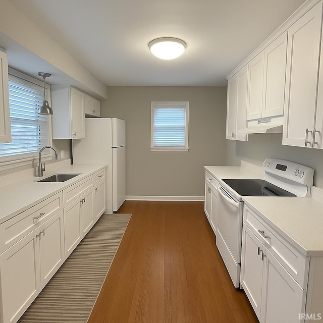204 Dehart St, West Lafayette, IN 47906 - kitchen with white appliances, a sink, under cabinet range hood, white cabinets, and dark wood-style flooring