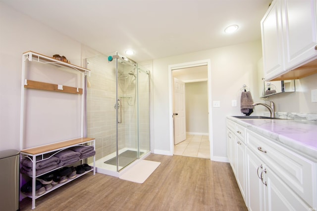 634 E Wildwood Dr, Warsaw, IN 46580 - bathroom with a stall shower, vanity, wood finished floors, recessed lighting, and baseboards