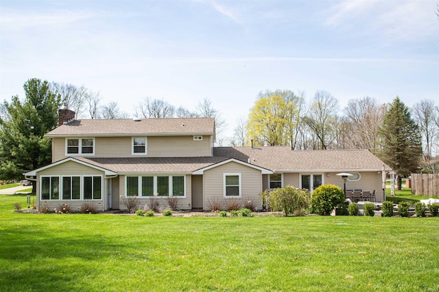 634 E Wildwood Dr, Warsaw, IN 46580 - rear view of property with a chimney, a yard, and a shingled roof