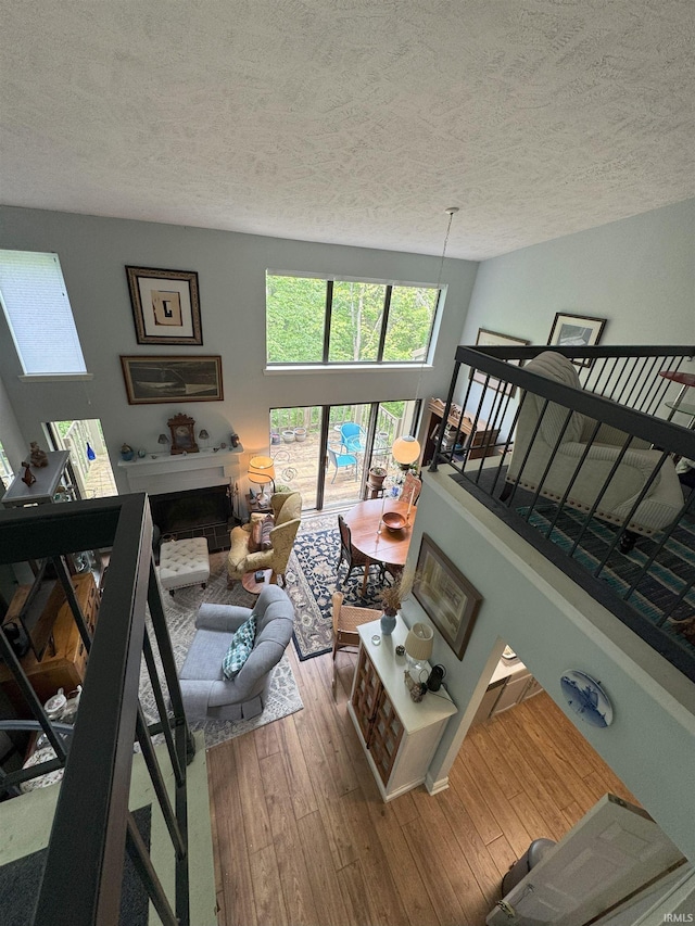 9384 S Lake Ridge Dr Unit 90, Bloomington, IN 47401 - living room featuring a textured ceiling and wood finished floors